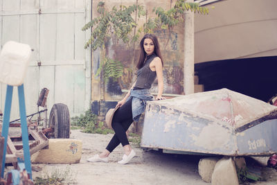 Portrait of young woman sitting outdoors