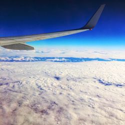 Cropped image of airplane flying over landscape