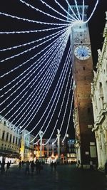 Low angle view of illuminated ferris wheel at night