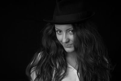 Portrait of young woman standing in darkroom