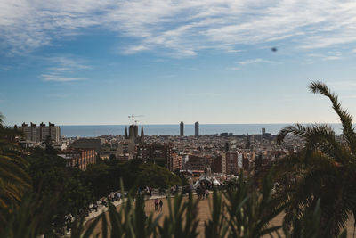 Scenic view of sea by buildings against sky