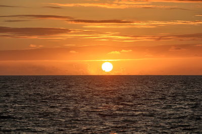 Scenic view of sea against orange sky