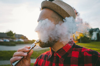 Close-up of hand holding object against blurred background