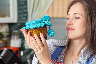 Close-up of woman holding container at home