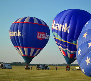 People in hot air balloon against clear sky