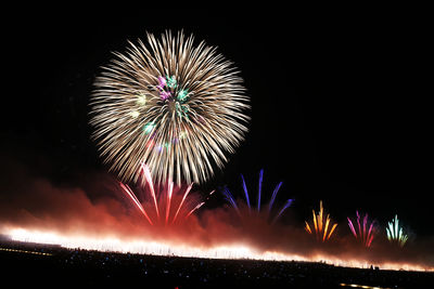 Low angle view of firework display at night