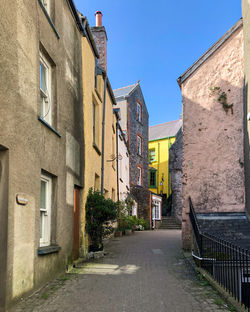 Street amidst buildings against sky in city