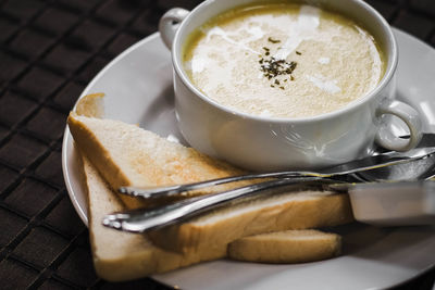 Cream of mushroom soup with garlic bread for bedfast meal in morning