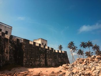 Low angle view of historical castle against blue sky