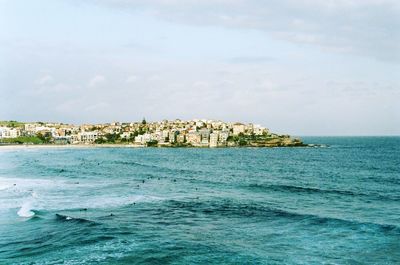 Scenic view of sea and buildings against sky