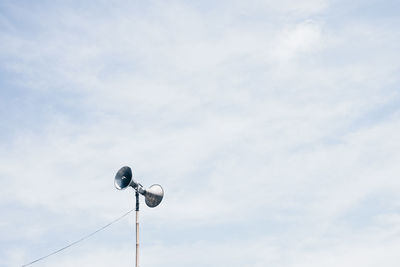 Low angle view of telephone against sky