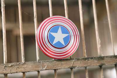 Close-up of flag against railing