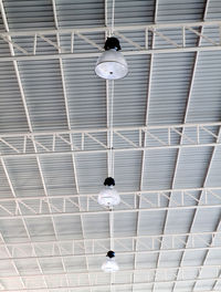 Low angle view of illuminated pendant lights hanging from ceiling