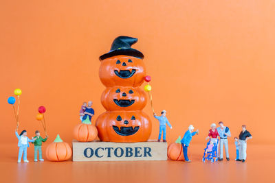 Close-up of stuffed toy against orange background