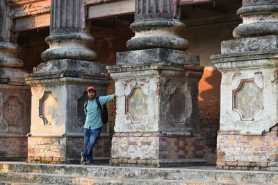 Full length of man standing against building