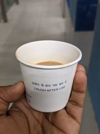 Midsection of person holding coffee cup