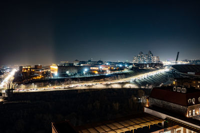 High angle view of illuminated buildings against sky at night