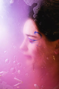 Close-up portrait of a beautiful young woman in water