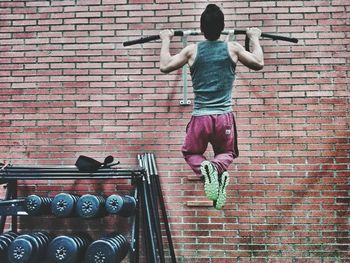 Rear view of man exercising in gym