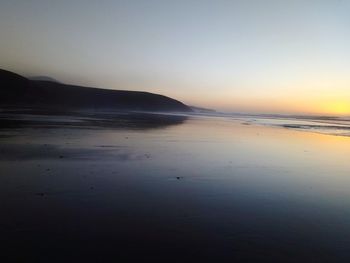 Scenic view of sea against clear sky during sunset