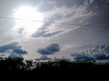 Low angle view of silhouette birds flying against sky