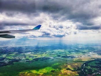 Aerial view of landscape against cloudy sky