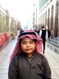 Portrait of cute boy wearing traditional clothing in city