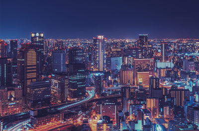 High angle view of illuminated city buildings against sky