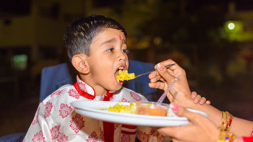 Full length of a boy eating food