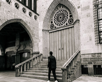 Rear view of man walking in building