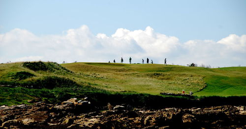 Scenic view of golf course against sky