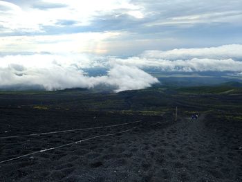 Scenic view of landscape against cloudy sky