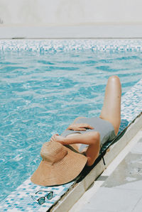 Woman sitting on swimming pool