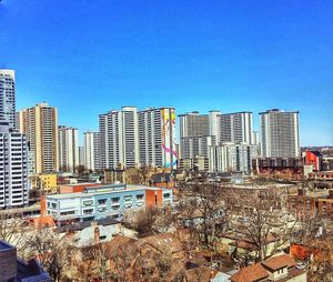 Buildings in city against blue sky