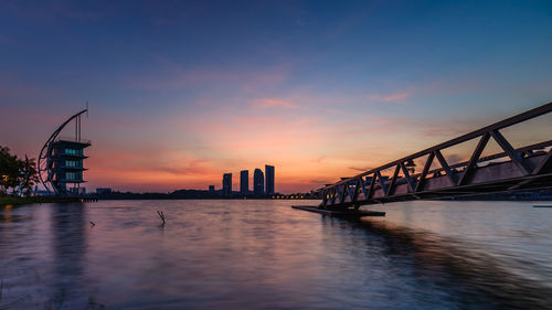 Bridge over river during sunset