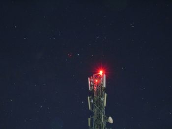 Low angle view of illuminated street light against sky at night