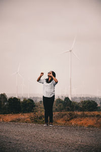 Full length of man standing on field against sky