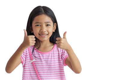 Portrait of smiling girl against white background