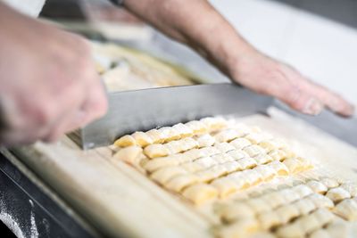 Cropped image of person preparing food in kitchen