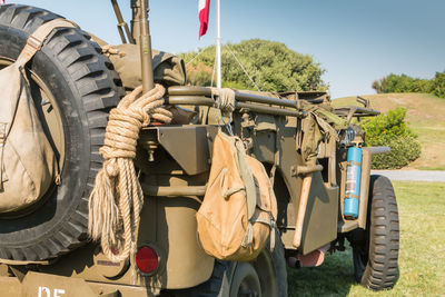 Close-up of tractor on field against clear sky