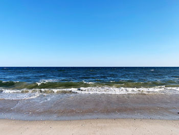 Scenic view of sea against clear blue sky