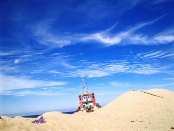 Scenic view of land against blue sky