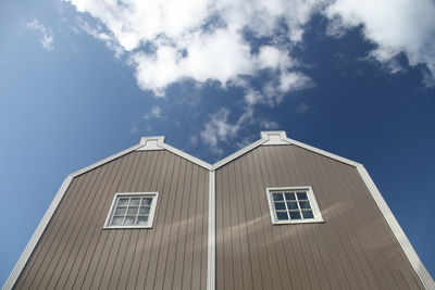 Low angle view of country facade against blue sky