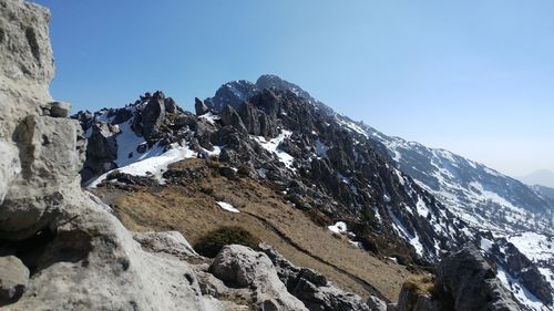 Scenic view of snowcapped mountains against clear sky