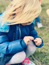 Girl crouching on grass