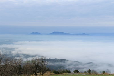 Scenic view of mountains against cloudy sky