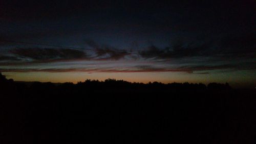 Low angle view of silhouette trees against sky at sunset