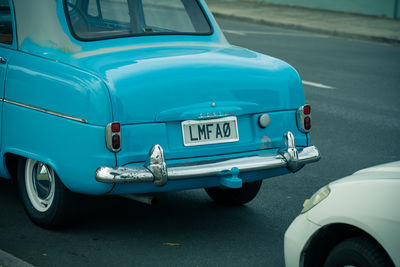 Close-up of vintage car on road