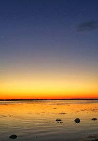 Scenic view of sea against clear sky during sunset