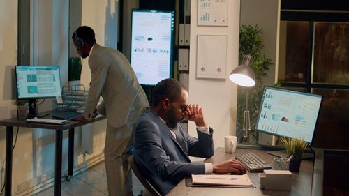 Side view of man using mobile phone in office